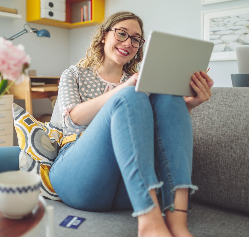 A woman on her tablet enjoys some Galentine's Day 2022 virtual experiences.