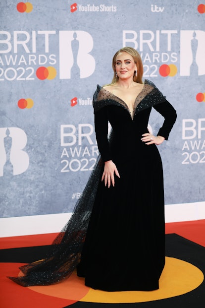 Adele wears a black custom Giorgio Armani Privé gown.