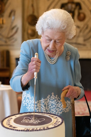 KING'S LYNN, ENGLAND - FEBRUARY 05: Queen Elizabeth II cuts a cake to celebrate the start of the Pla...