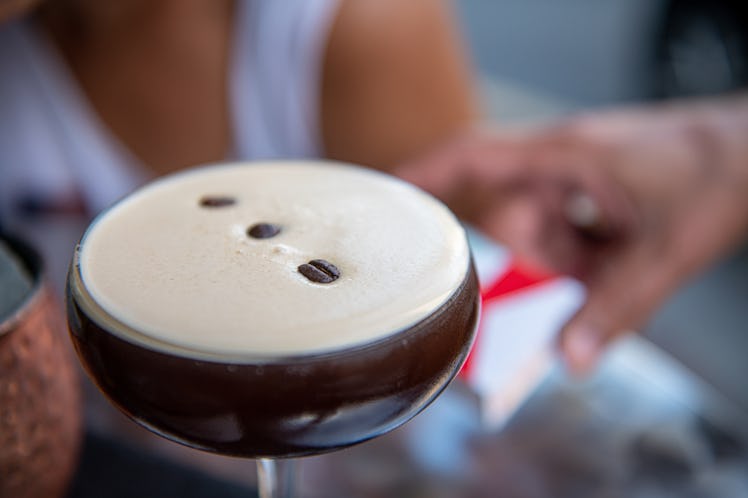 A woman enjoys a espresso martini that she can post to Instagram with espresso martini captions. 