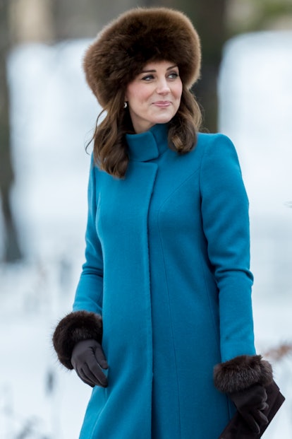 Kate Middleton at a sculpture park in a blue coat and fur hat in Oslo in 2018.