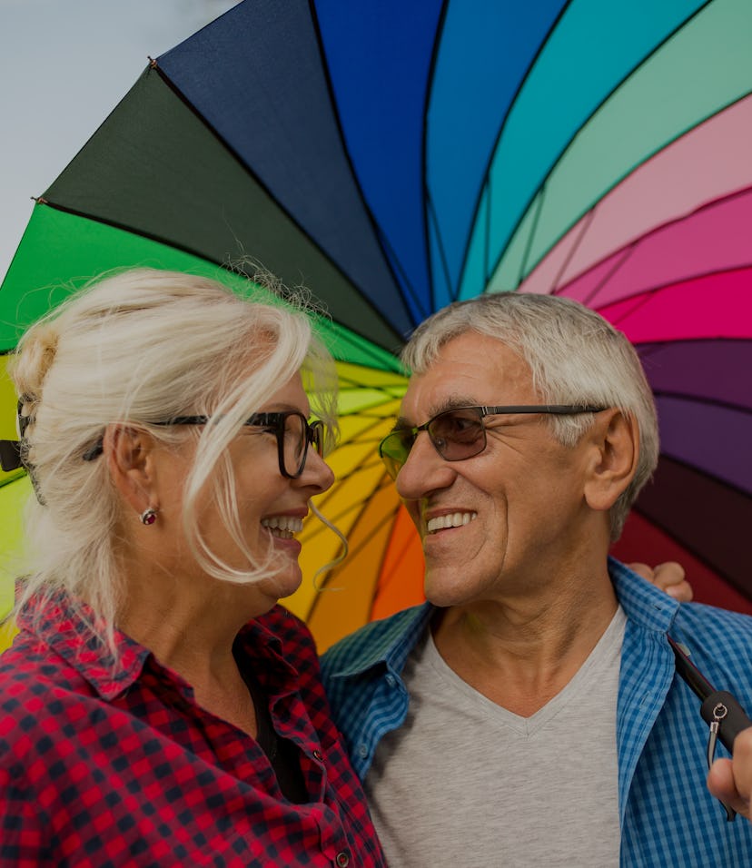 The old couple in the rain with umbrellas