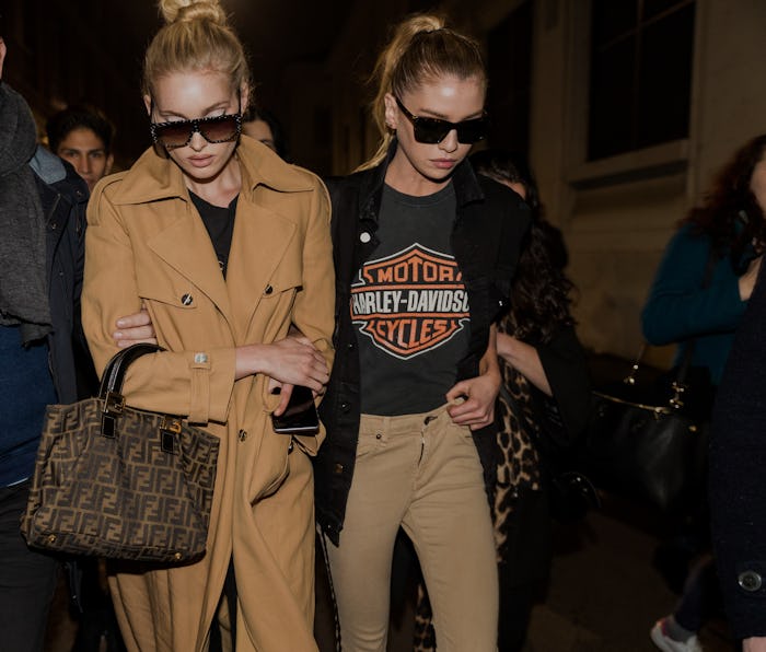 MILAN, ITALY - FEBRUARY 23: Model Elsa Hosk wearing a beige coat and Stella Maxwell wearing a Harley...