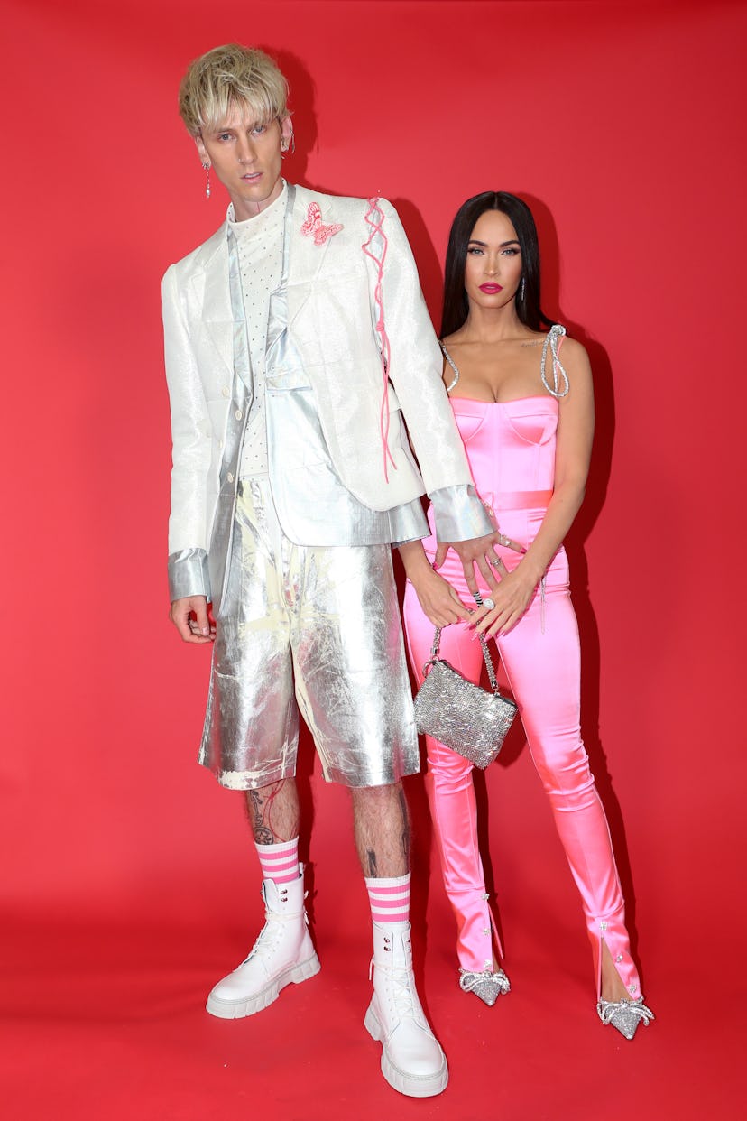 Megan Fox in a pink satin two-piece and Machine Gun Kelly in a metallic suit.