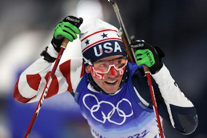 Jake Brown of Team United States looks on during Men's Biathlon 20km wearing tape on his face.