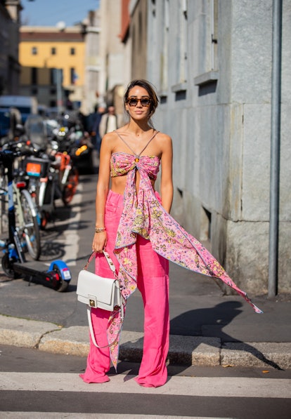 MILAN, ITALY - FEBRUARY 25: Tamara Kalinic seen wearing pink wrapped off shoulder top, pink pants, w...