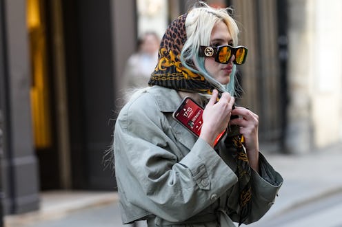 PARIS, FRANCE - FEBRUARY 28: A guest wears sunglasses from Gucci, a black with yellow gold print pat...