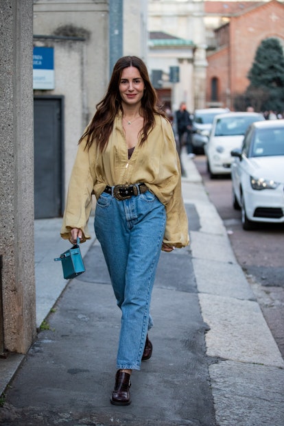 MILAN, ITALY - FEBRUARY 23: Gala Gonzalez seen wearing beige button shirt, high waist denim jeans, b...