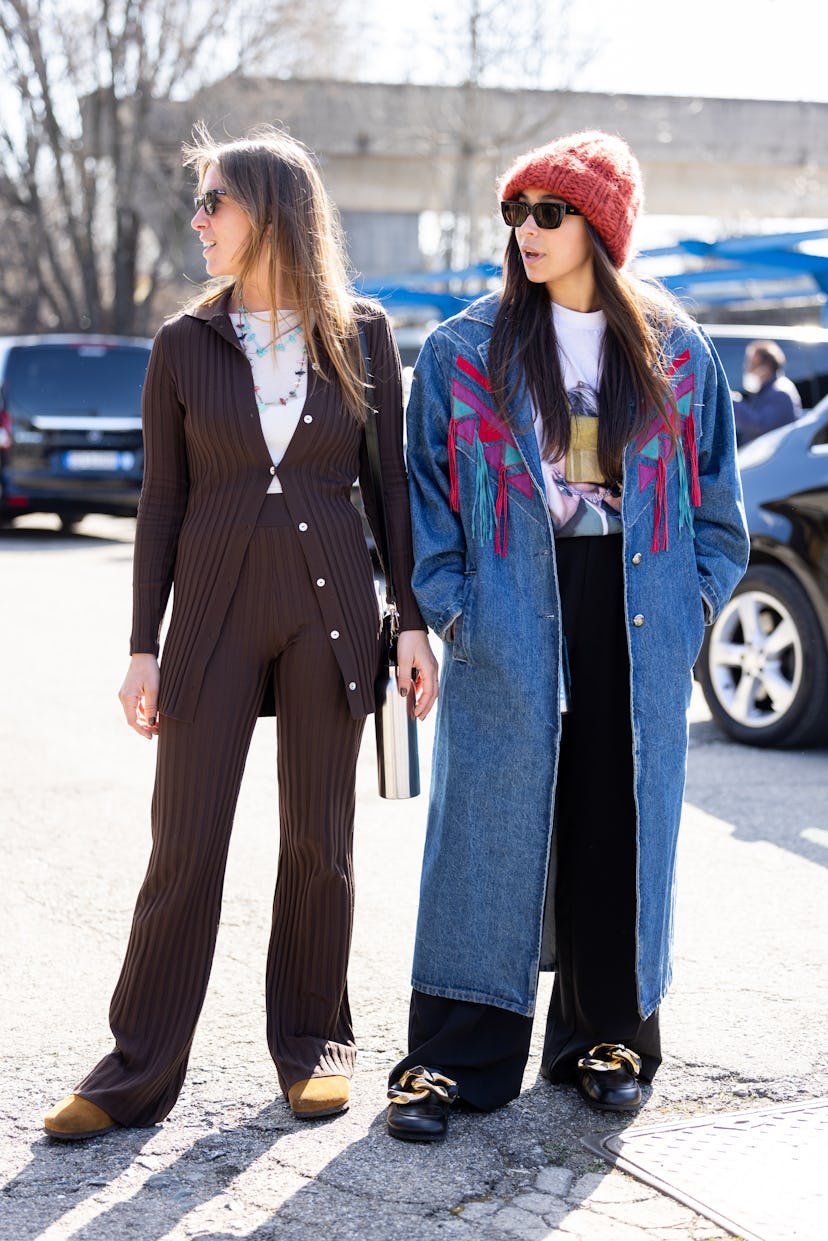 MILAN, ITALY - FEBRUARY 27: Two guests are seen ahead of the Dsquared2 fashion show during the Milan...