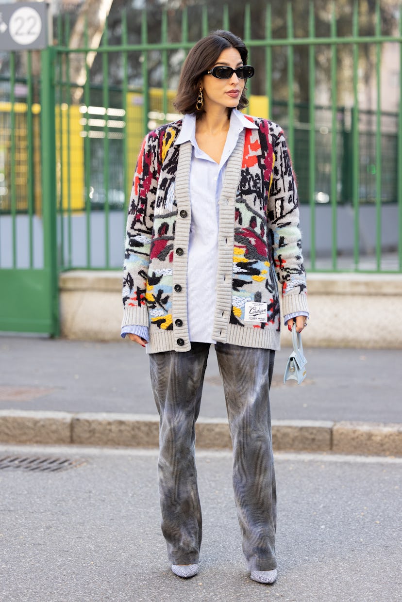 MILAN, ITALY - FEBRUARY 25: A guest is seen ahead of the Missoni fashion show wearing a printed card...