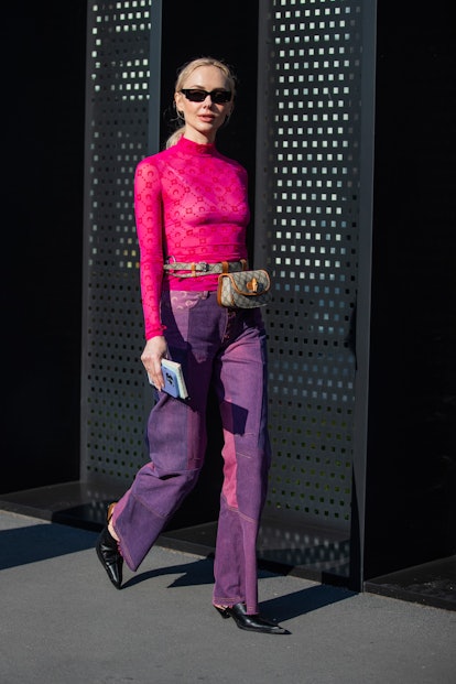 MILAN, ITALY - FEBRUARY 25: Olga Karput is seen wearing pink top, purple pants, Gucci bag outside Gu...