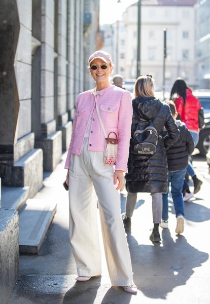 MILAN, ITALY - FEBRUARY 26: Kate Gelinsky is seen wearing pink jacket, creme white pants, bag, cap o...