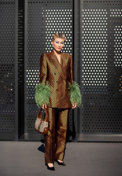 MILAN, ITALY - FEBRUARY 25: Amalie Gassmann seen wearing brown blazer & pants, bag outside Gucci fas...