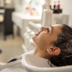Woman getting her hair washed, still used for article about Olaplex