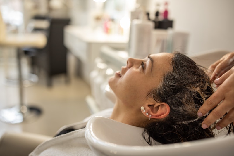 Woman getting her hair washed, still used for article about Olaplex