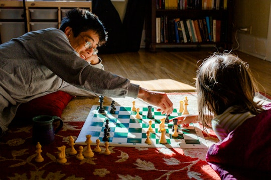 dad and daughter playing a board game