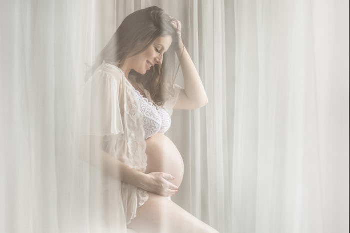 woman in boudoir maternity photo shoot