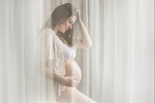 woman in boudoir maternity photo shoot