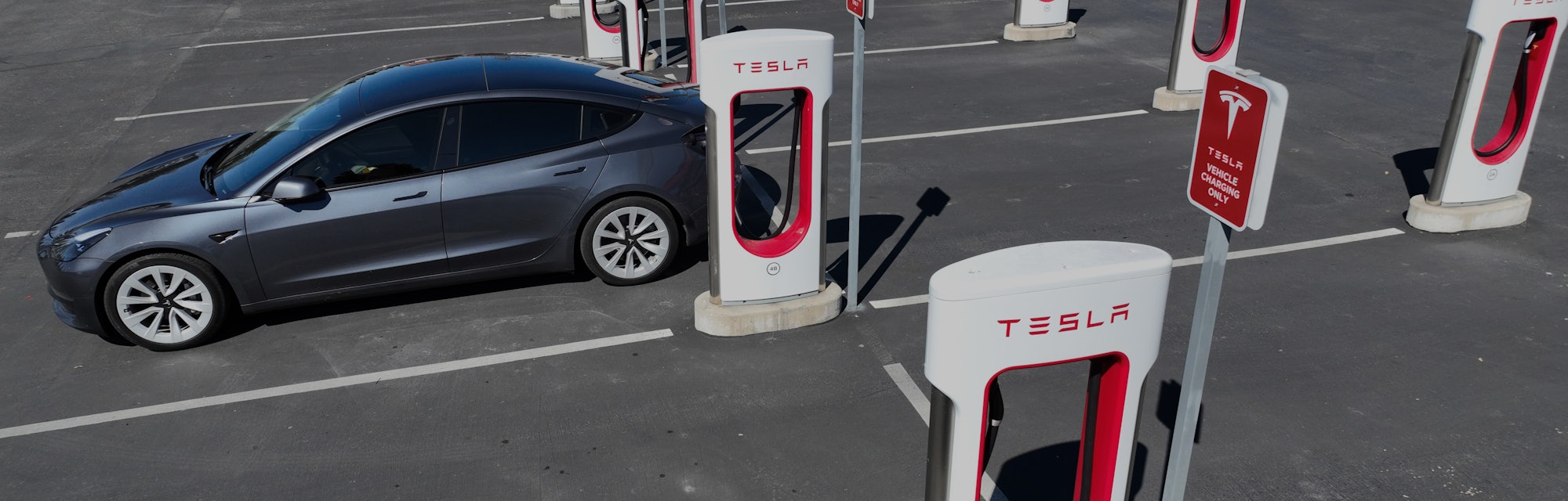 PETALUMA, CALIFORNIA - MARCH 09: In an aerial view, a Tesla car recharges its battery at the Petalum...