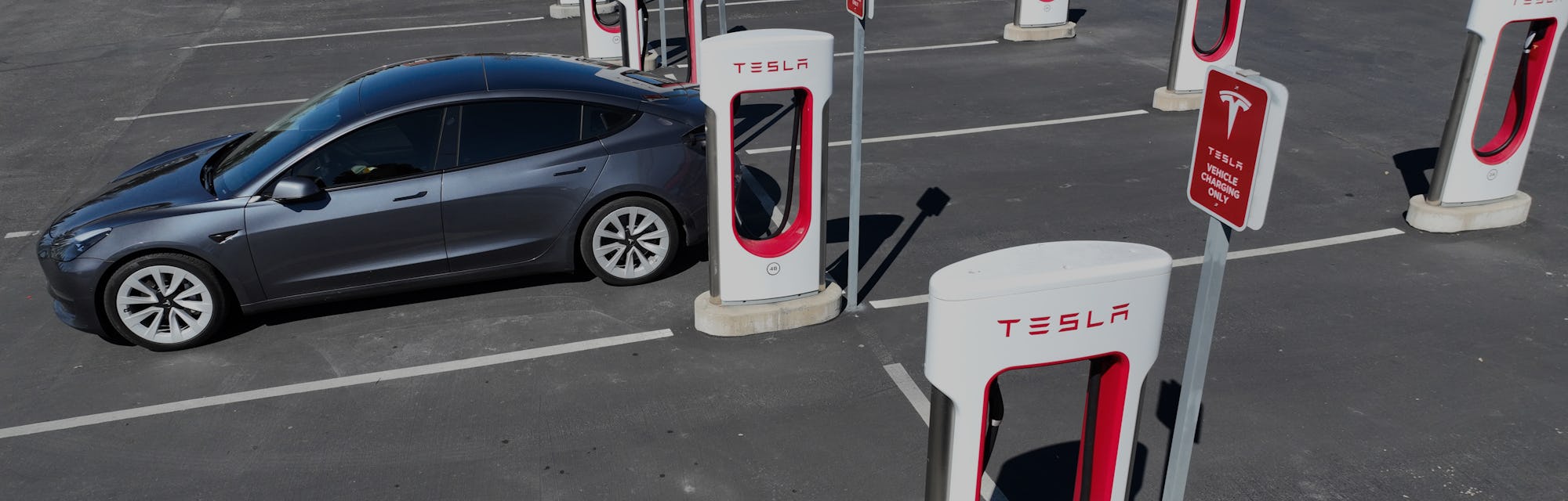 PETALUMA, CALIFORNIA - MARCH 09: In an aerial view, a Tesla car recharges its battery at the Petalum...