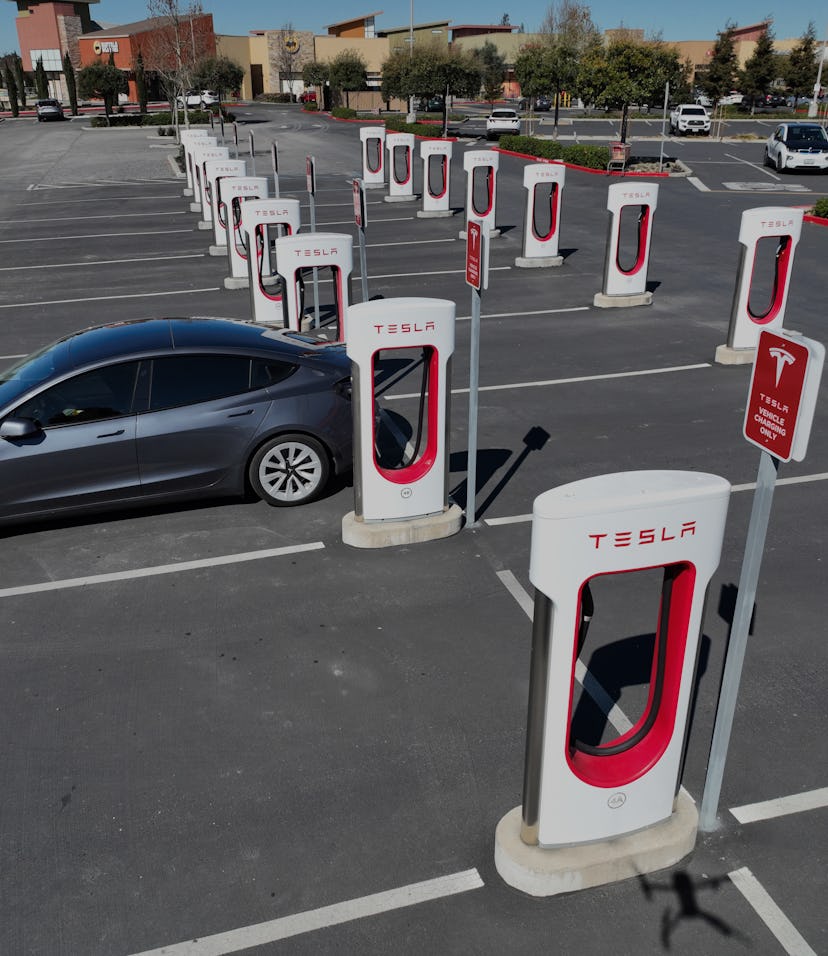 PETALUMA, CALIFORNIA - MARCH 09: In an aerial view, a Tesla car recharges its battery at the Petalum...