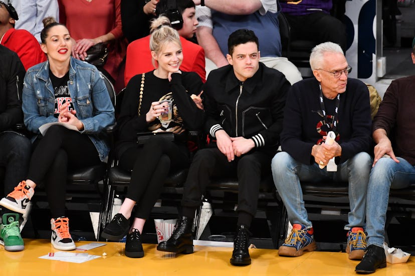LOS ANGELES, CALIFORNIA - JANUARY 29: Rami Malek and Lucy Boynton attend a basketball game between t...
