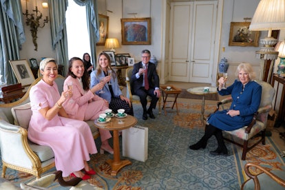 Britain's Camilla, Duchess of Cornwall (R) poses for a photograph with Kat Cordiner, Charlotte Irvin...