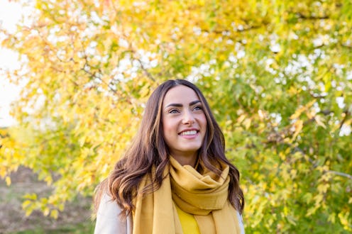 woman matching with the tree behind her outdoors