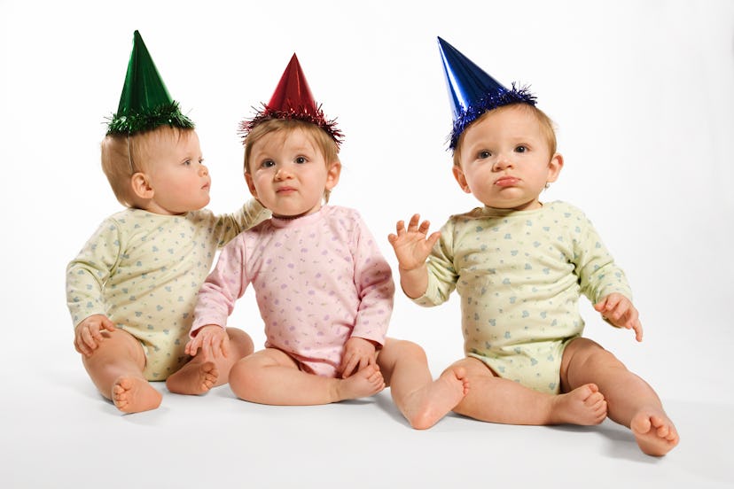 three babies with party hats