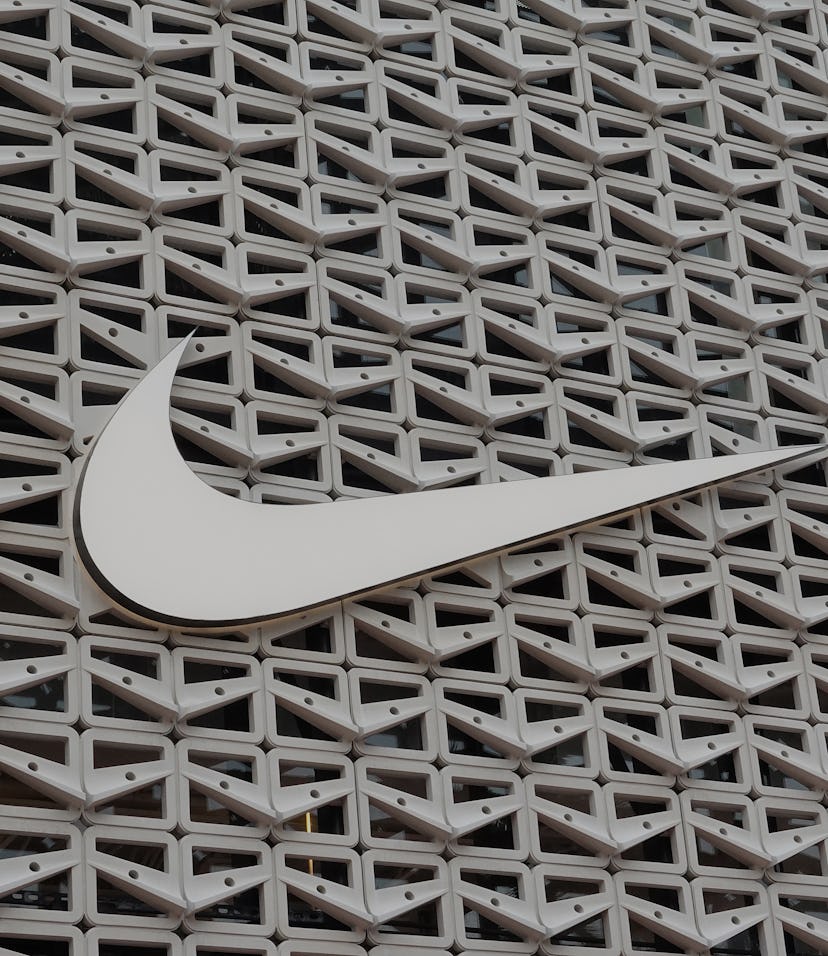 MIAMI BEACH, FLORIDA - DECEMBER 21: The Nike logo hangs above the entrance to the Nike store on Dece...