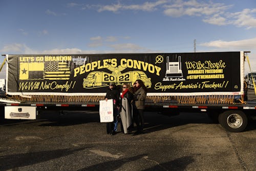 People gather to rally with truckers at the start of "The Peoples Convoy" protest against Covid-19 v...