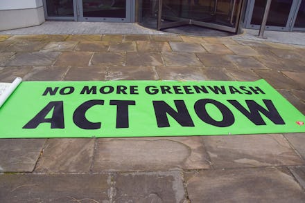 LONDON, UNITED KINGDOM - 2021/12/15: 'No More Greenwash: Act Now' banner is seen during the demonstr...