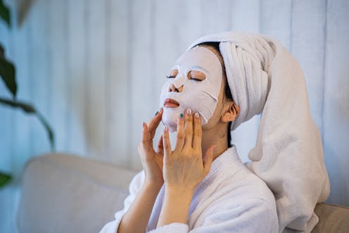 Woman with purifying mask on her face