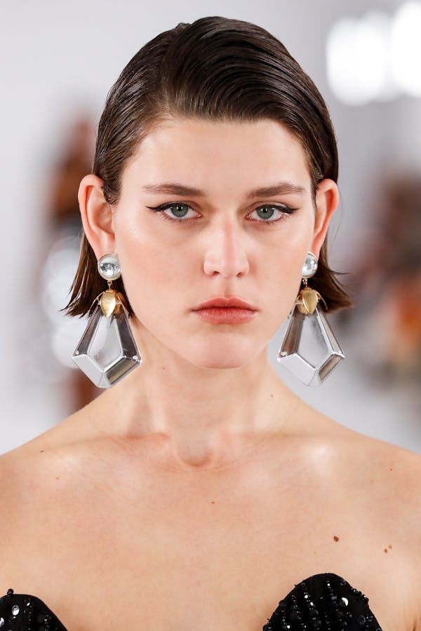 a model wearing large crystal earrings on the Carolina Herrera runway