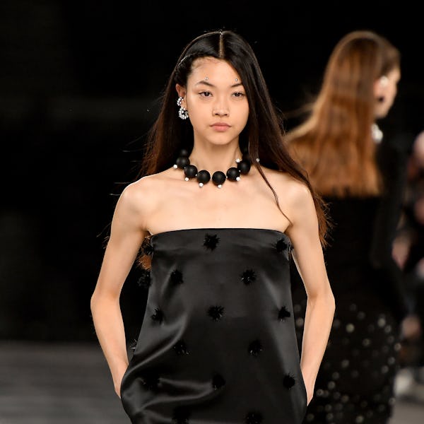 a model wearing a thick ball necklace on the Givenchy runway