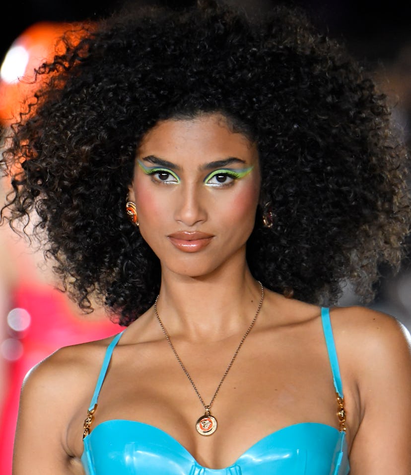 MILAN, ITALY - SEPTEMBER 24: Imaan Hammam walks the runway during the Versace Ready to Wear Spring/S...
