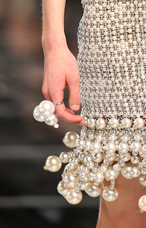 a model wearing a large pearl ring on the Givenchy runway