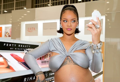 Rihanna wearing a silver bra top.