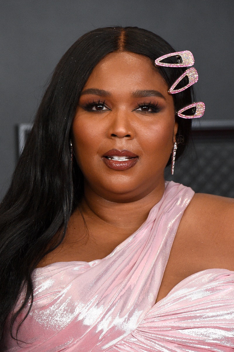 Lizzo in hair clips and a pink dress. 