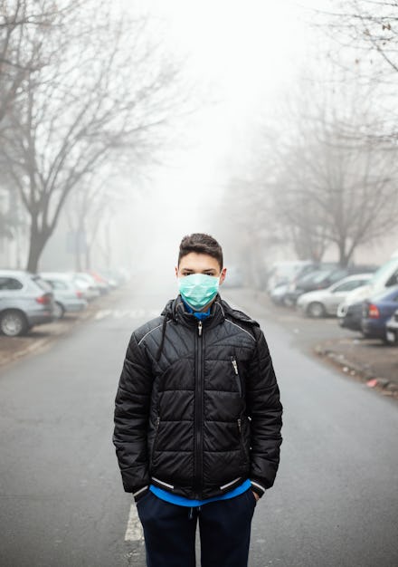 Young man with facial mask during air pollution