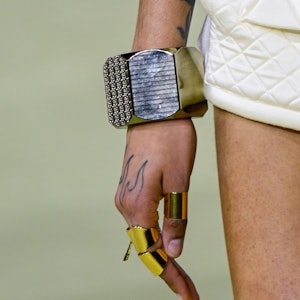 a model wearing a thick silver bangle bracelet on the Balmain runway