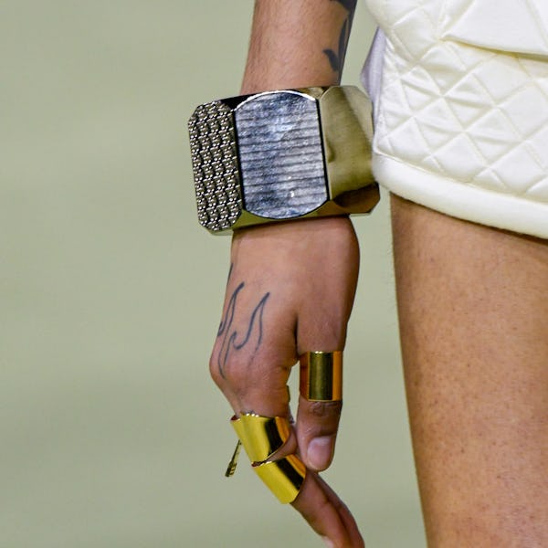 a model wearing a thick silver bangle bracelet on the Balmain runway