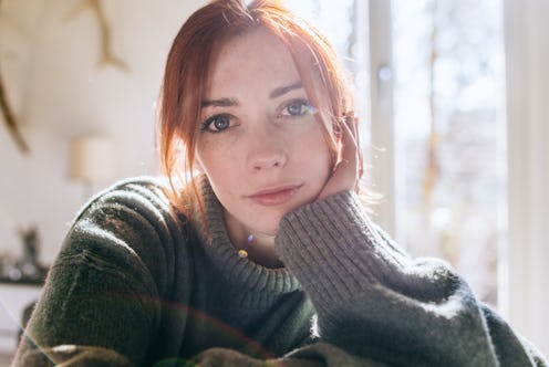 Portrait of a thoughtful looking young woman at home.