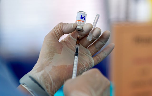 A healthcare worker prepping a syringe with the Covid vaccine, which Pfizer CEO Albert Bourla says s...