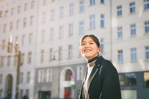 A woman in a city stands outside and smiles at the camera. An astrologer reveals Taurus' hidden powe...