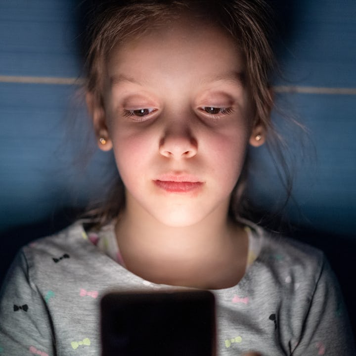 A girl scrolling through social media on her phone, which lawmakers say big tech knows is addictive ...