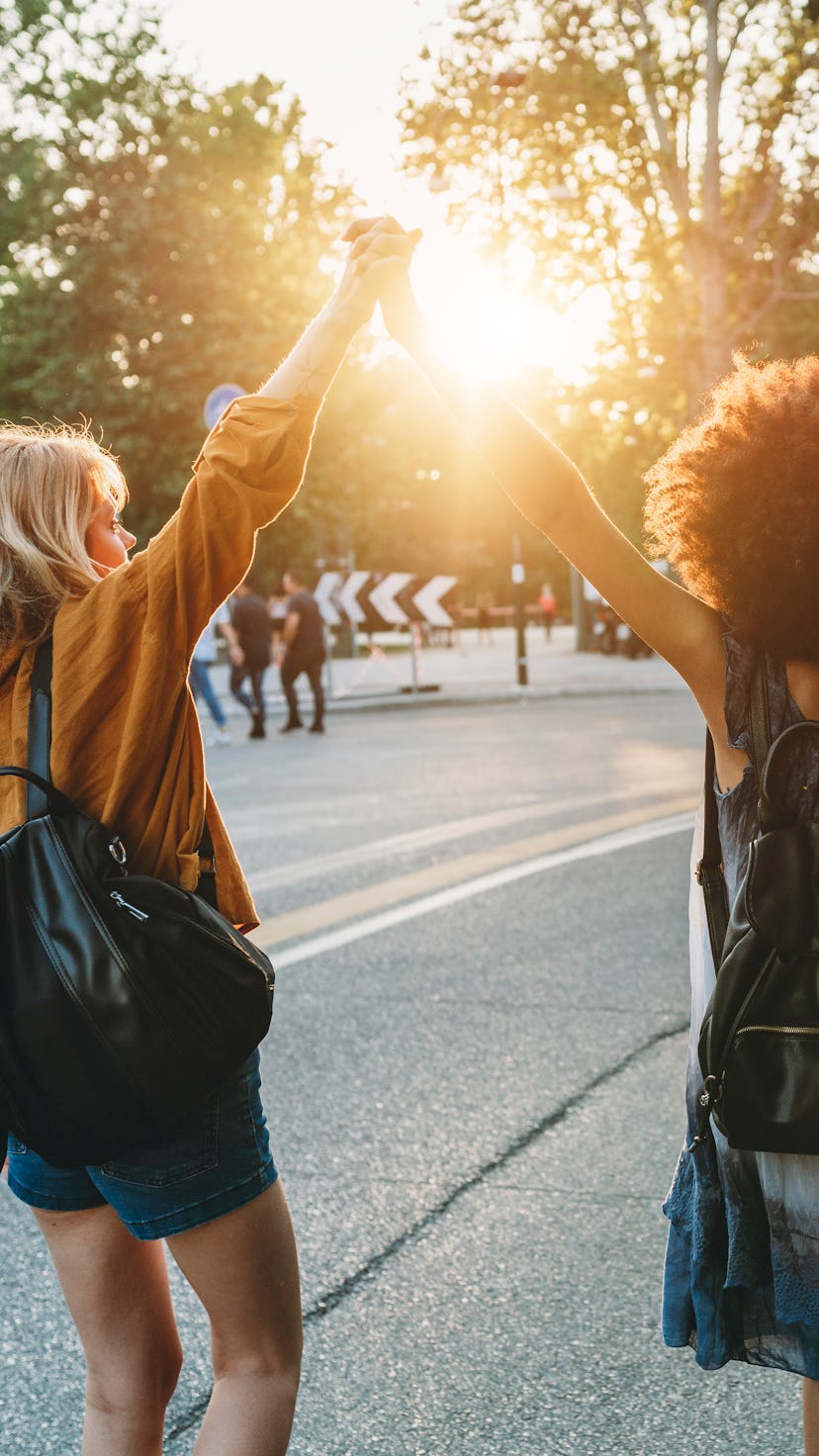 Two friends walking together in the city at sunset. The senate's Sunshine Protection Act would make ...