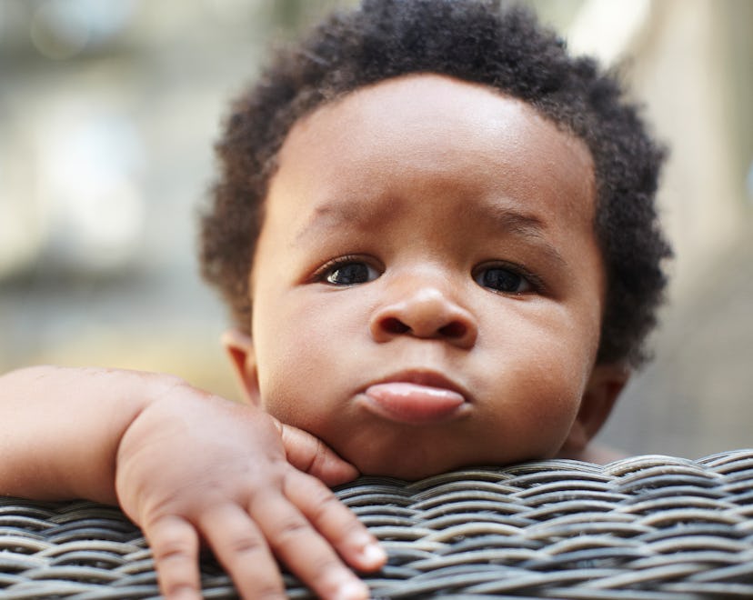 baby boy looking over chair