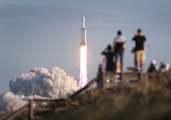 TITUSVILLE, FLORIDA - APRIL 11: People watch as the SpaceX Falcon Heavy rocket lifts off from launch...