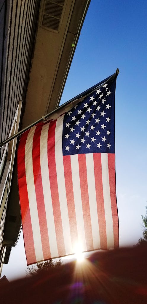 An american flag waves in the sun. Daylight saving time would be permanent starting in 2023.